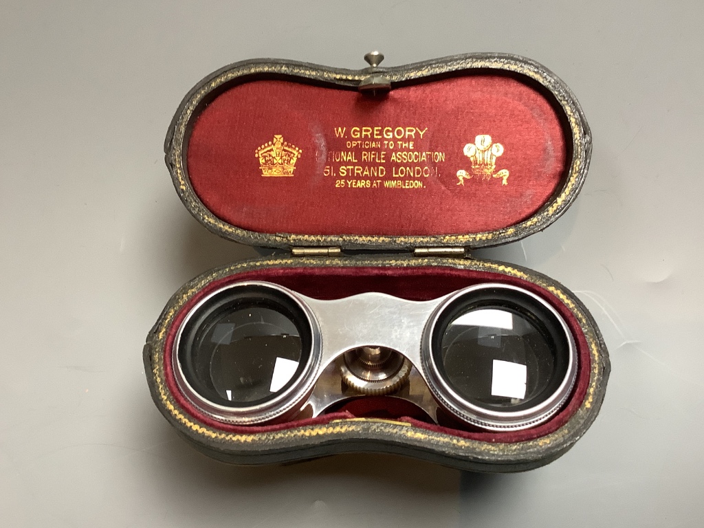 A cased pair of mother of pearl opera glasses, 6cm